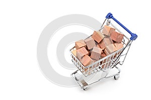 Shopping chart or supermarket trolley with Wooden toy cubes