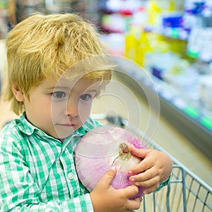 Shopping with children at store. Little baby boy in supermarket. Joint purchases in a supermarket with a child. Cute