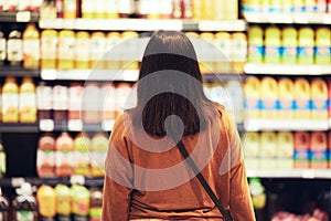 Shopping, choice or woman at supermarket for grocery, decision or product search for sale, discount or bargain. Economy