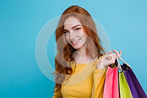 Shopping Concept - Close up Portrait young beautiful attractive redhair girl smiling looking at camera with shopping bag