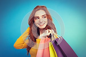 Shopping Concept - Close up Portrait young beautiful attractive redhair girl smiling looking at camera with shopping bag