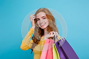 Shopping Concept - Close up Portrait young beautiful attractive redhair girl smiling looking at camera with shopping bag