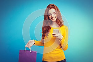 Shopping Concept - Close up Portrait young beautiful attractive redhair girl smiling looking at camera with shopping bag