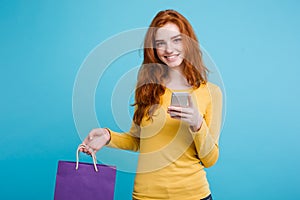 Shopping Concept - Close up Portrait young beautiful attractive redhair girl smiling looking at camera with shopping bag