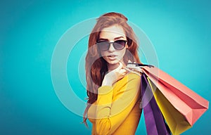 Shopping Concept - Close up Portrait young beautiful attractive redhair girl smiling looking at camera with shopping bag