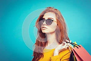 Shopping Concept - Close up Portrait young beautiful attractive redhair girl smiling looking at camera with shopping bag