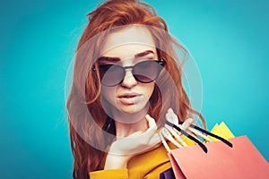 Shopping Concept - Close up Portrait young beautiful attractive redhair girl smiling looking at camera with shopping bag