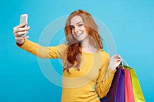 Shopping Concept - Close up Portrait young beautiful attractive redhair girl smiling looking at camera with white