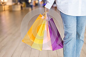 Shopping fashion lifestyle. Women wear holding shopping bag colorful mall. Female relaxation shopping