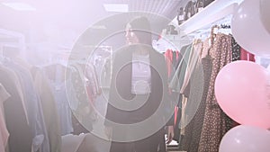 Shopping girl. Portrait of a beautiful woman in the clothes store. Young attractive brunette eastern girl in clothing