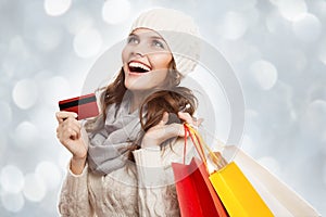 Shopping happy woman holding bags and credit card. Winter sales.