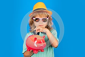 Shopping. Kid saving coin money with piggy bank. Cash and investment. Boy collecting money to money box piggybank.