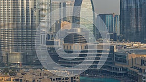 Shopping mall exterior with reataurants near fountain in Dubai downtown aerial morning timelapse, United Arab Emirates