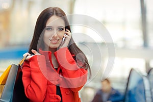 Shopping Mall Girl in a Red Coat Talking on Smartphone