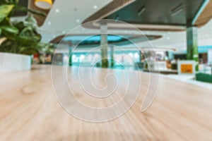 Shopping mall interior blurred background. People shopping in modern commercial mall center. Interior of retail centre store in