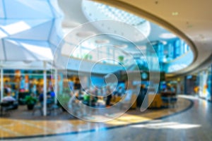 Shopping mall people blurred background. People shopping in modern commercial mall center. Interior of retail centre store in soft