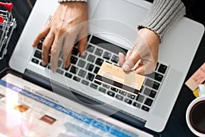 Shopping online concept. Woman holding gold credit card in hand