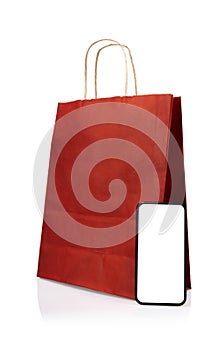 Shopping online concept with paper bags on smartphone isolated on white