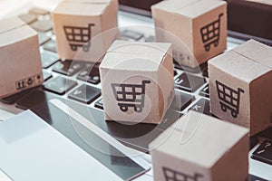 Shopping online. Credit card and cardboard box with a shopping cart logo on laptop keyboard. Shopping service on The online web.