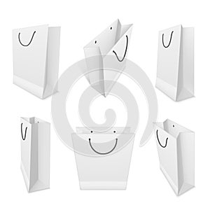 Shopping paper bags realistic mockups set. White blank packaging with rope handles templates.