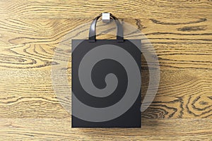 Shopping or present concept with front view on blank dark craft bag with silver handles and space for company logo or advertising