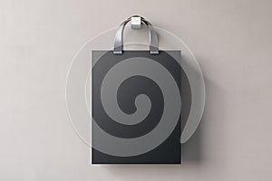 Shopping or present concept with front view on blank dark craft bag with silver handles and space for company logo or advertising