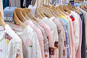 A shopping rank filled with clothes, pajamas and robes.