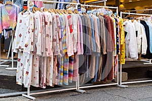 A shopping rank filled with clothes, pajamas and robes.