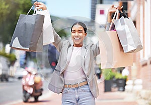 Shopping, retail and celebration with a young woman and consumer in the city after spending money in a store, shop or