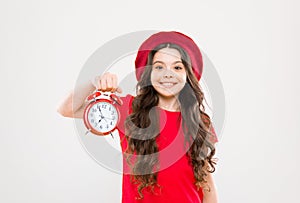 Shopping, sales and time concept. parisian child on yellow. child with alarm clock. Timeless fashion. happy girl with