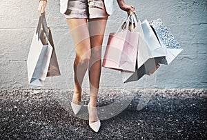 Shopping, spending and fashion with a woman carrying bags, looking for a sale or bargain and enjoying retail therapy