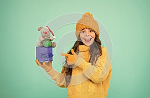 In shopping store. happy new 2020 year. rat symbol of year. small happy girl hold mouse. kid knitted sweater and hat