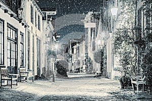 Shopping street with snowfall in the Dutch city center of Deventer photo