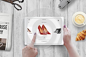 Shopping with tablet. Woman buy red shoes on online market