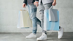 Shopping therapy couple walking holding bags