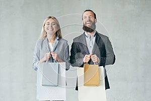 Shopping therapy happy smiling couple hold bags
