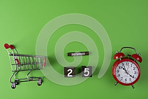 Shopping time concept. Supermarket trolley with alarm clock
