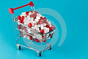 Shopping trolley cart filled red medicinal capsules