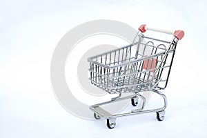 Shopping trolley cart on white background. Copy space for your text. Online shopping, buy mall market shop consumer concept.