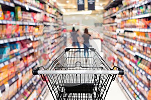 Shopping trolley in department store with goods shelf background