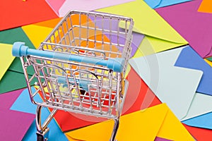 Shopping trolley and different envelopes on the desk