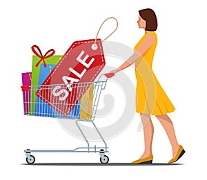 Shopping trolley or full of colorful gift boxes. Shopping carts full of shopping bags and gift boxes. Concept of discoun