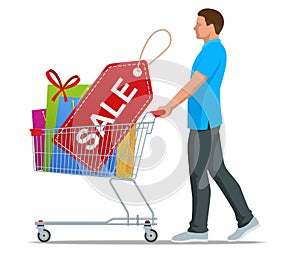 Shopping trolley or full of colorful gift boxes. Shopping carts full of shopping bags and gift boxes. Concept of discoun