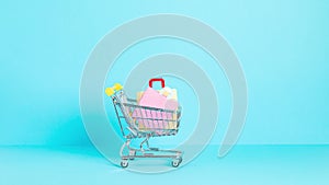 Shopping trolley full of paper bags. Sesonal sale, online deals, discounts, promotion, shopping addiction concept. Stop motion