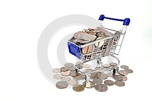 Shopping trolley or Shopping cart full of coins money isolated o