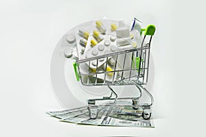 Shopping trolley with tablets and money.