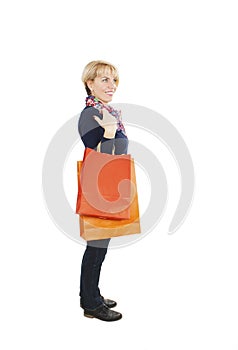 Shopping woman holding shopping bags looking at something. Beautiful Caucasia/European shopper smiling happy.Studio shot