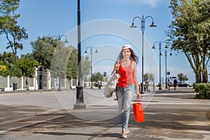 Shopping woman walking though avenues photo