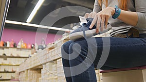 Shopping for women - girl chooses a shoes in mall