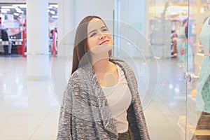 Shopping A young girl looks at shop windows, chooses gifts in a mall